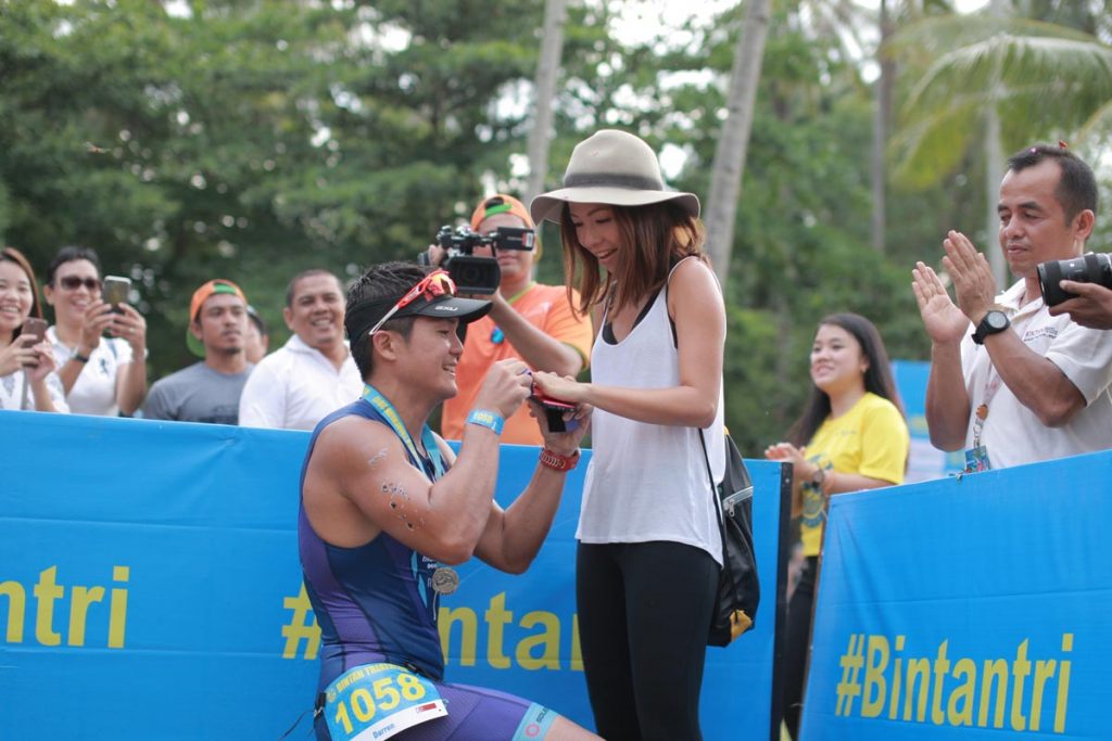 Darren Ho on his knees for his finish line marriage proposal